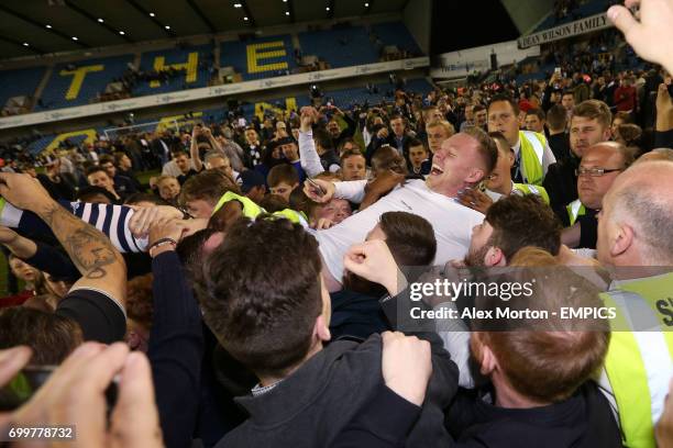 Millwall's Aiden O'Brien is carried by fans at the end of the match