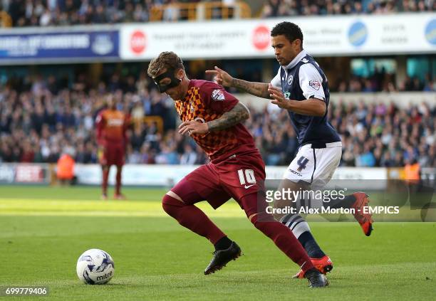 Bradford City's Billy Clarke and Millwall's Carlos Edwards in action