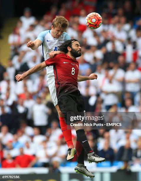 England's Eric Dier and Turkey's Selcuk Inan battle for the ball in the air