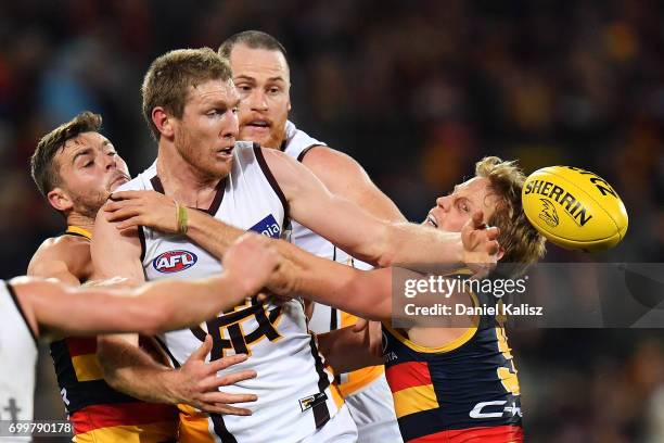 Players compete for the ball during the round 14 AFL match between the Adelaide Crows and the Hawthorn Hawks at Adelaide Oval on June 22, 2017 in...