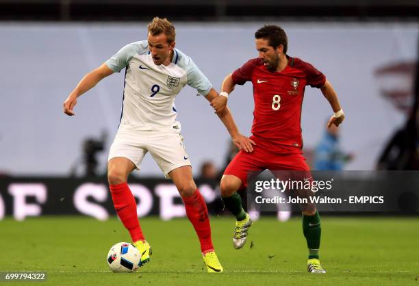 England's Harry Kane and Portugal's Joao Moutinho battle for the ball