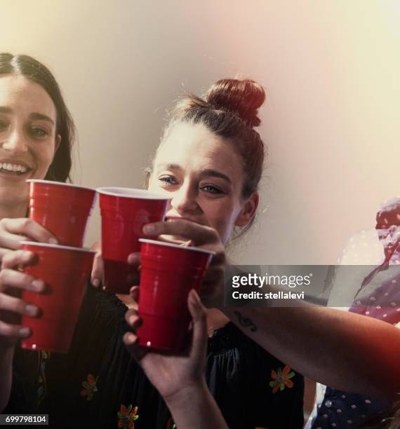cheers- drinking at a party - beer pong stock pictures, royalty-free photos & images