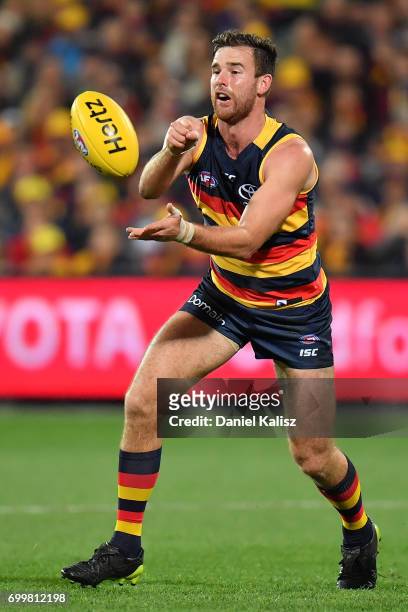 Andy Otten of the Crows handballs during the round 14 AFL match between the Adelaide Crows and the Hawthorn Hawks at Adelaide Oval on June 22, 2017...