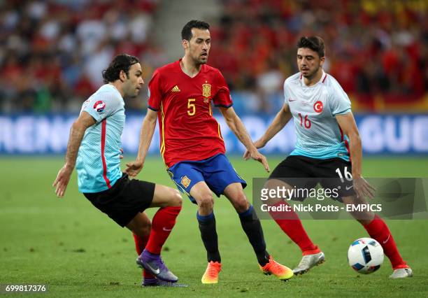 Spain's Sergio Busquets in action with Turkey's Selcuk Inan and Ozan Tufan