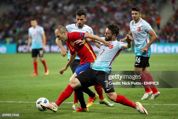 Spain's Andres Iniesta in action with Turkey's Gokhan Gonul and Oguzhan Ozyakup