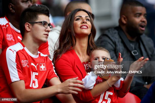 Erjona Sulejmani, girlfriend of Switzerland's Blerim Dzemaili and their son Luan in the stands before the game.