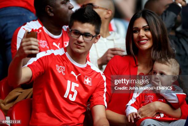 Erjona Sulejmani, girlfriend of Switzerland's Blerim Dzemaili and their son Luan in the stands before the game.