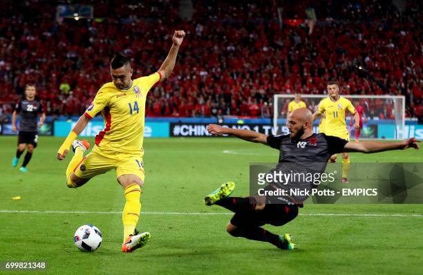 Romania's Florin Andone has an attempt on goal as Albania's Arlind Ajeti slides in