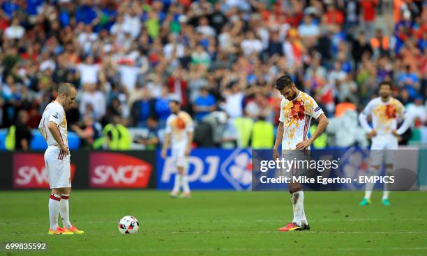 Spain's Andres Iniesta and Cesc Fabregas look dejected after conceeding a second goal.