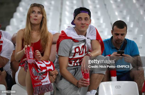 Poland fans look dejected after the match.