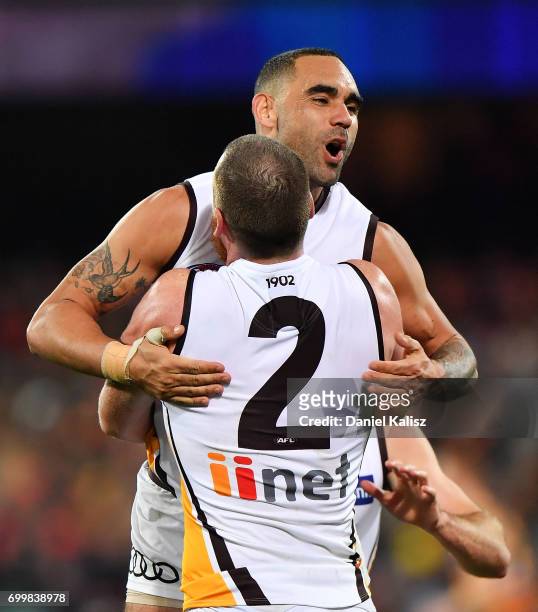 Shaun Burgoyne celebrates with Jarryd Roughead of the Hawks after kicking a goal during the round 14 AFL match between the Adelaide Crows and the...