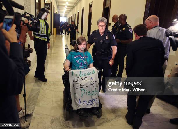 Capitol Police remove a protester from in front of the office of Senate Majority Leader Mitch McConnell inside the Russell Senate Office Building on...