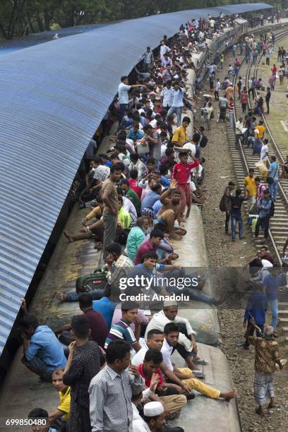 Bangladeshi people board an overcrowded train to travel their home towns for the upcoming Eid Al-Fitr, which marks the end of the Muslims' holy...