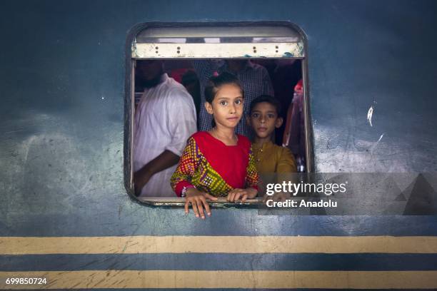 Bangladeshi people board an overcrowded train to travel their home towns for the upcoming Eid Al-Fitr, which marks the end of the Muslims' holy...