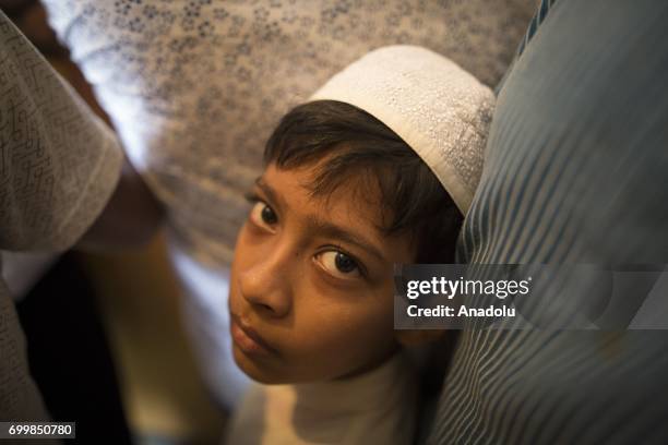 Bangladeshi people board an overcrowded train to travel their home towns for the upcoming Eid Al-Fitr, which marks the end of the Muslims' holy...