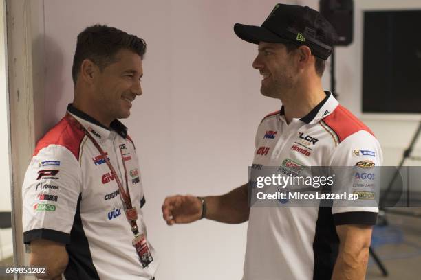 Cal Crutchlow of Great Britain and LCR Honda smiles with Lucio Cecchinello of Italy and LCR Honda MotoGP during the press conference pre-event during...