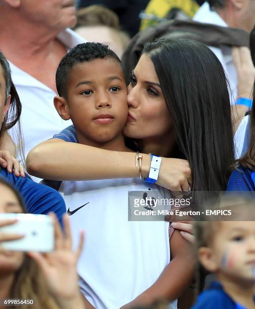 Ludivine Sagna, wife of France's Bacary Sagna and their son Elias in the stands before the game.