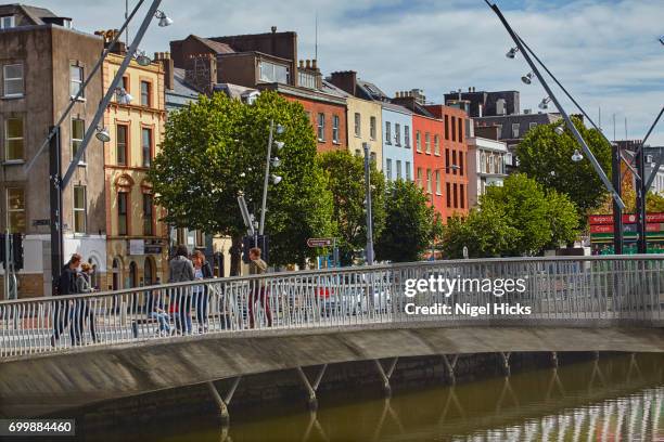 a footbridge across the river lee south channel, in downtown cork, ireland. - river lee cork stock pictures, royalty-free photos & images