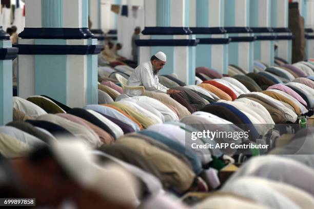 Pakistani Muslim offer evening prayers at a mosque in Karachi on June 22, 2017 on Lailat al-Qader, also known as the Night of Power, and the 27th...