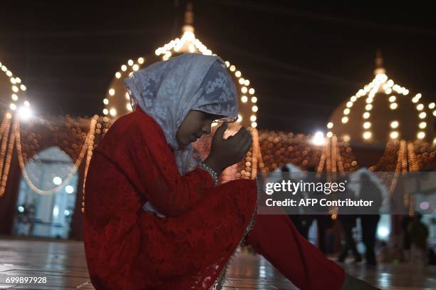 Young Pakistani girl prays at a mosque in Karachi on June 22, 2017 on Lailat al-Qader, also known as the Night of Power, and the 27th night of the...