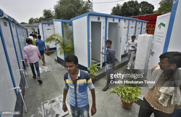 People using the toilets inaugurated by Delhi Chief Minister Arvind Kejriwal at JJ Basti, Madrasi Basti near Railway Line, Lajpat Nagar on June 22,...