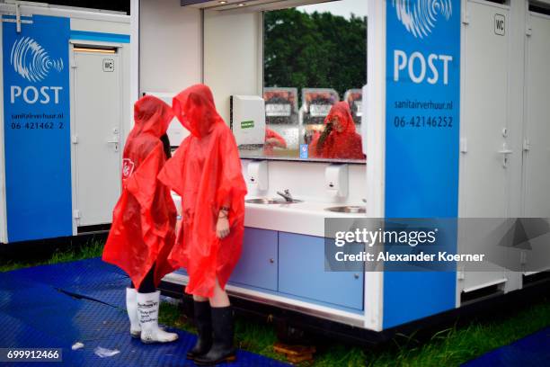 Festival goers in rainjackets are seen at the sanitary installations ahead the Hurricane Festival 2017 on June 22, 2017 in Scheessel, Germany. The...