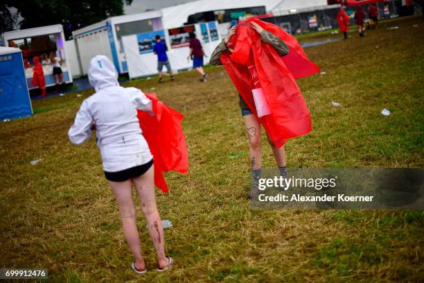 Festival goers walk on the muddy camping compound ahead the Hurricane Festival 2017 on June 22, 2017 in Scheessel, Germany. The area of the festival...