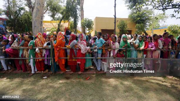 Devotees wait to offer prayers at the shrine of Sufi saint Baba Dalip Singh Chamliyal during the annual fair, at the India-Pakistan border, in...