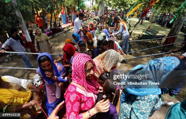 Devotees wait to offer prayers at the shrine of Sufi saint Baba Dalip Singh Chamliyal during the annual fair, at the India-Pakistan border, in...