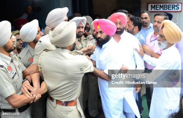 Lok Insaaf Party MLA Simarjit Singh Bains and AAP MLA Sukhpal Khaira trying to forcibly enter to Punjab Assembly on June 22, 2017 in Chandigarh,...