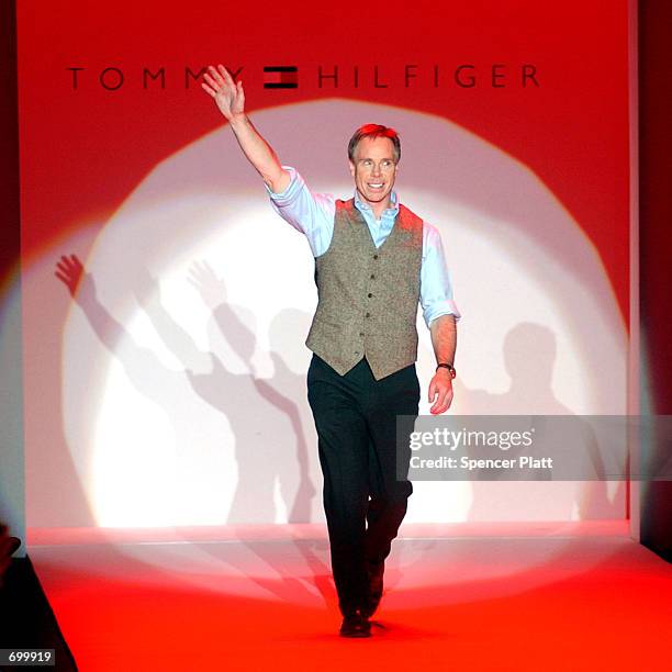 Designer Tommy Hilfiger waves to the audience at the conclusion of the Tommy Hilfiger Fall 2002 menswear collection as Fashion Week kicks off...