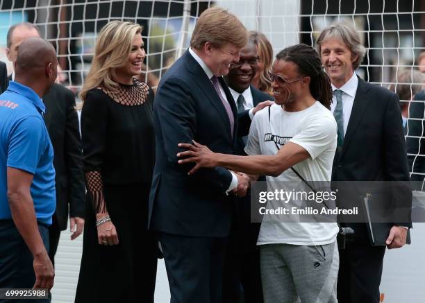 King Willem-Alexander of the Netherlands shakes hands with Edgar Davids during a football clinic for integration organized by Italian Football...