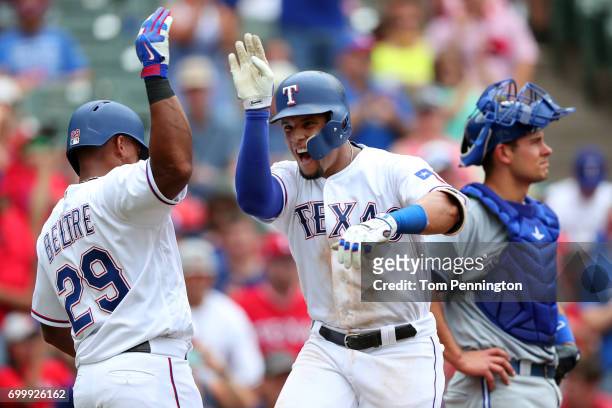 Carlos Gomez of the Texas Rangers celebrates with Adrian Beltre of the Texas Rangers after hitting a three run home run against the Toronto Blue Jays...