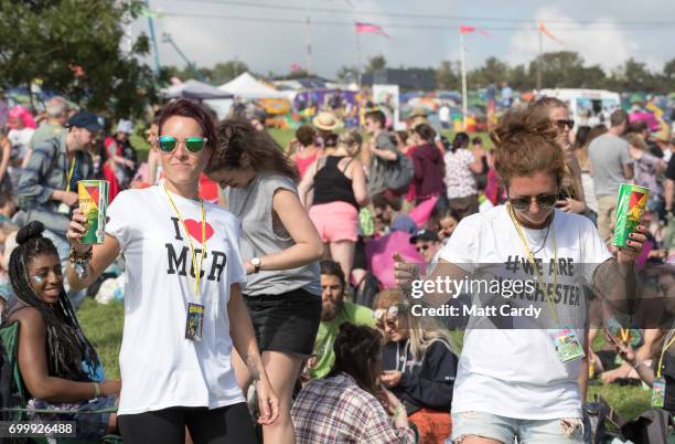 People dance in front of the Pyramid Stage at the Glastonbury Festival site at Worthy Farm in Pilton on June 22, 2017 near Glastonbury, England. The...