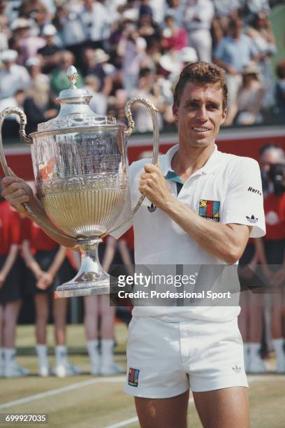 Czechoslovak tennis player Ivan Lendl holds the trophy after defeating South African tennis player Christo van Rensburg, 4-6, 6-3, 6-4 to win the...