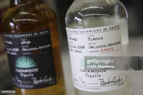 Bottles of Casamigos anejo, and reposado tequilas are arranged for a photograph at a liquor store in Los Angeles, California, U.S., on Thursday, June...