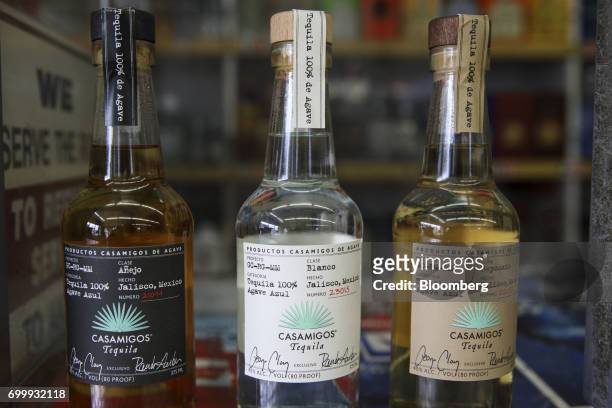 Bottles of Casamigos anejo, blanco, and reposado tequilas are arranged for a photograph at a liquor store in Los Angeles, California, U.S., on...
