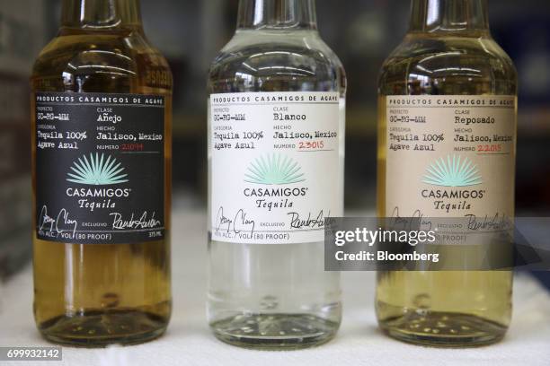 Bottles of Casamigos anejo, blanco, and reposado tequilas are arranged for a photograph at a liquor store in Los Angeles, California, U.S., on...