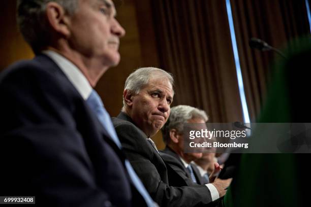 Martin Gruenberg, chairman of the Federal Deposit Insurance Corp. , center, and Jerome Powell, governor of the U.S. Federal Reserve, left, listen...