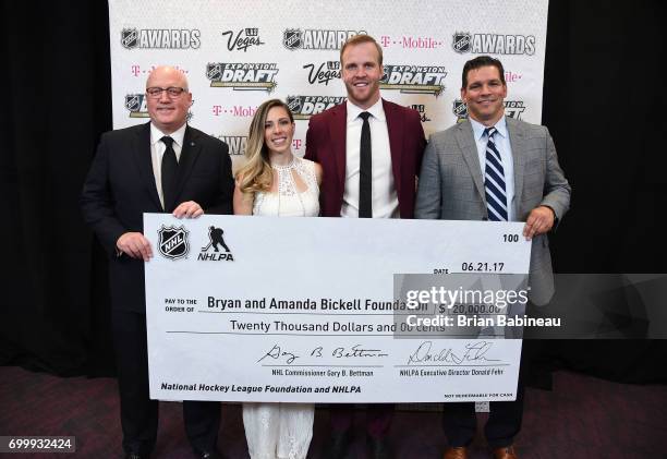 Deputy Commissioner Bill Daly, Amanda Bickell, Bryan Bickell and Steve Webb of the NHLPA pose with a check donation to the Bryan and Amanda Bickell...