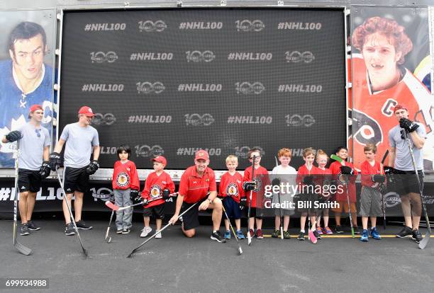 Top draft prospects Nico Hischier, Casey Mittelstadt and Nolan Patrick pose with youth hockey player and 100 Greatest NHL Player Denis Savard during...