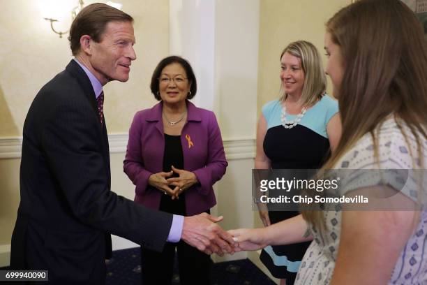 Sens. Richard Blumenthal and Mazie Hirono talk with Jill Hile of Hilliard, Ohio, whose daughter Allison lives with cystic fibrosis, following a news...