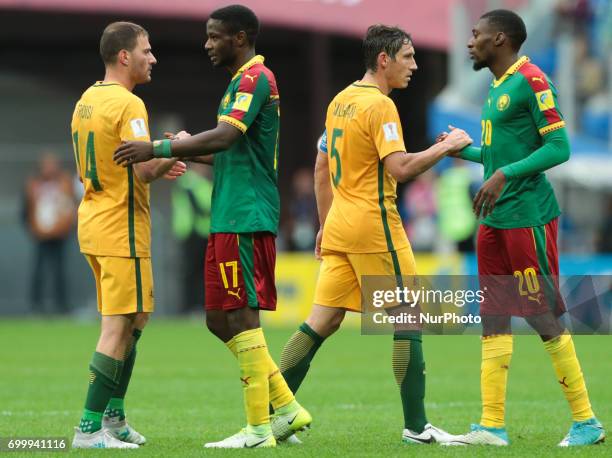 James Troisi , Mark Milligan of the Australia national football team and Arnaud Djoum , Karl Toko Ekambi of the Cameroon national football team after...