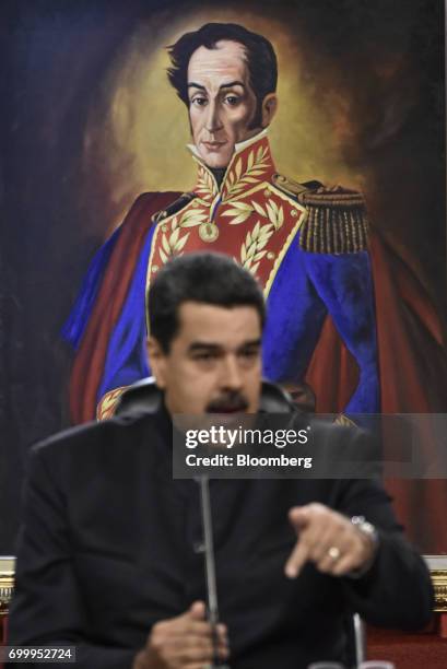 Painting of Venezuelan political leader Simon Bolivar is displayed behind Nicolas Maduro, president of Venezuela, during a press conference in...
