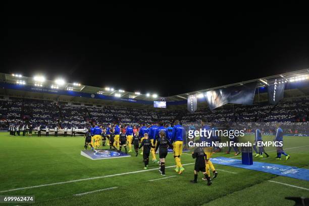 Leicester City and FC Porto players walk out onto the pitch ahead of kick off