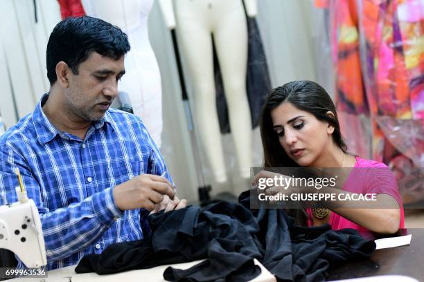 Dubai based fashion designer Aiisha Ramadan is seen on June 10, 2017 in her studio in Dubai, United Arab Emirates. From Dolce & Gabbana to Michael...