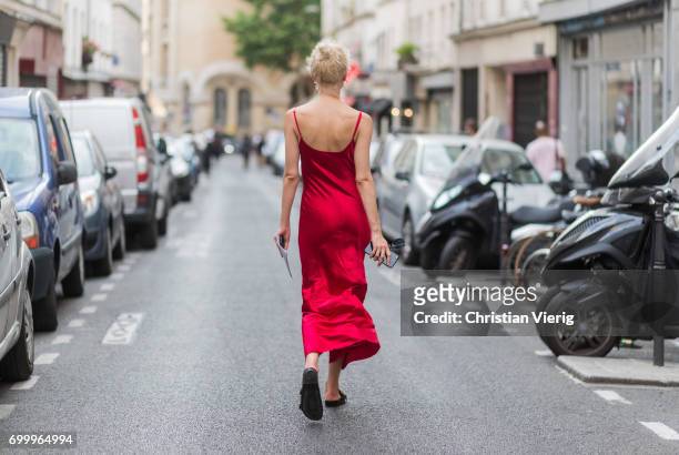 Olga Karput wearing a red silk dress outside Dries van Noten during Paris Fashion Week - Menswear Spring/Summer 2018 on June 22, 2017 in Paris,...