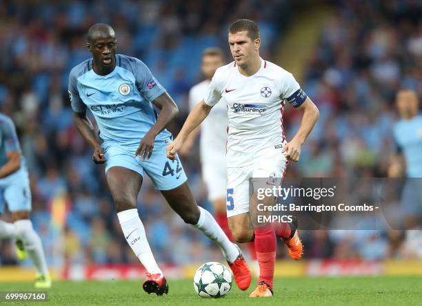 Manchester City's Yaya Toure and Steaua Bucharest's Jugurtha Hamroun battle for the ball