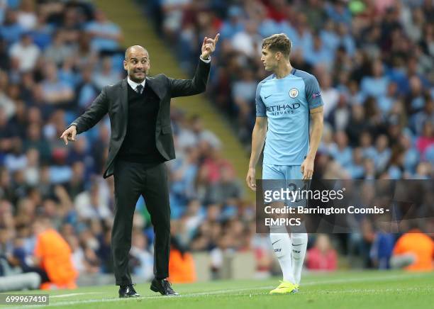 Manchester City's manager Pep Guardiola and John Stones during the game against Steaua Bucharest