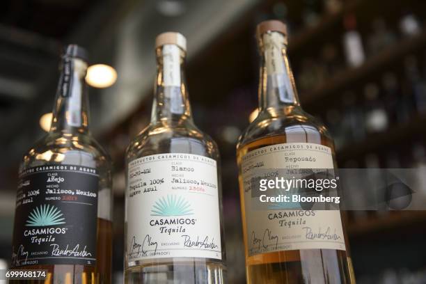 Bottles of Casamigos anejo, blanco, and reposado tequila are arranged for a photograph at a restaurant in Los Angeles, California, U.S., on Thursday,...